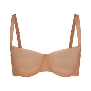 SKIMS no show unlined balconette bra in color ochre